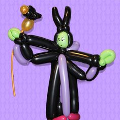 an inflatable balloon figure with two balloons attached to it's arms and feet