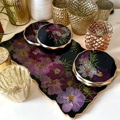 a table topped with plates and vases filled with flowers