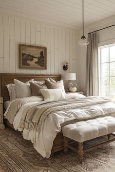 a large bed sitting in a bedroom on top of a wooden floor next to a window