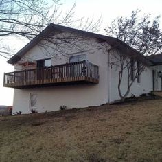 a large white house sitting on top of a hill