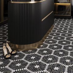 a black and white tiled floor next to a counter with high heels on the ground