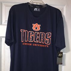 an auburn university t - shirt hanging on a door