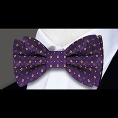 Radiant Royalty: The Purple and Gold Geometric Silk Bow Tie Step into the world of regal elegance with our Purple and Gold Geometric Silk Bow Tie. A true masterpiece, this bow tie boasts a captivating geometric pattern that effortlessly marries the richness of purple with the opulence of gold. Whether you choose the self-tie or pre-tied option, this accessory is a statement piece that will elevate your style to royal heights. Let's explore the details that make this bow tie a crown jewel in the Elegant Purple Bow Tie For Party, Elegant Purple Party Ties, Purple Bow Tie For Party, Purple Party Bow Tie, Elegant Multicolor Bow Tie, Elegant Bow With Butterfly Knot For Black-tie Events, Elegant Fitted Multicolor Bow Tie, Elegant Pre-tied Bow For Gift, Elegant Fitted Bow For Gift