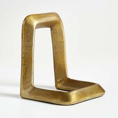 a gold metal object on a white background