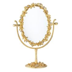 an ornately decorated gold mirror on a stand