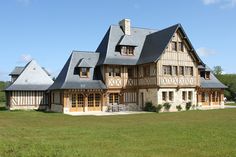 a large house with lots of windows and wood trimmings on the side of it