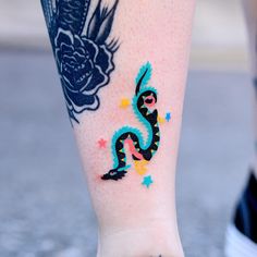 a close up of a person's foot with tattoos on it and a dragon