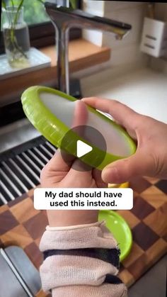 a person holding a green object in their hand with the caption my dad should have used this instead