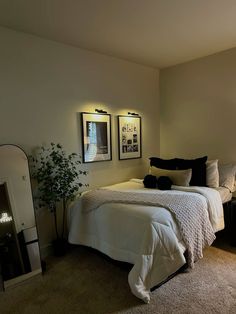 a bedroom with two framed pictures on the wall