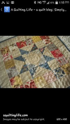 a quilted table topper with many different colors and designs on the fabric,