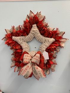 a red and white wreath hanging on the wall