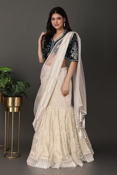 Off-white lehenga with a detachable drape having beads and thread hand embroidered borders. Comes with a navy blue jaal work padded blouse. - Aza Fashions Transitional Organza Sharara With Traditional Drape, Raw Silk Sharara With Traditional Drape For Reception, Wedding Pre-draped Saree With Dori Work, Traditional Drape Lehenga With Unstitched Blouse, White Pre-draped Saree With Dori Work, Wedding Floor-length Pre-draped Saree With Dori Work, Unstitched Organza Choli With Traditional Drape, Traditional Drape Sharara With Resham Embroidery For Reception, Traditional Drape Blouse Piece With Dori Work For Wedding