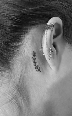 a woman's ear with an arrow tattoo on it