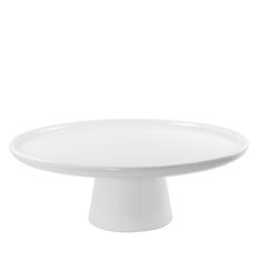 a white cake plate sitting on top of a table