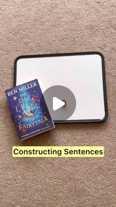 a book and cd sitting on top of a carpeted floor next to the words constructing sentences