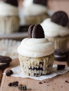 an oreo cookie cupcake with white frosting and chocolate chips