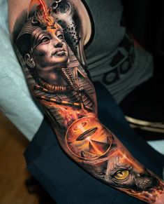 a man with a tattoo on his arm has an owl and woman's face