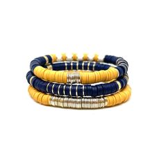 "This lightweight, colorful soft Navy Gold African disc bracelets are a perfect way to add a little sparkle to any outfit:). It is an easy on stretch bracelet that can be worn by itself or stacked. The bracelet is 7\" with a gold plated barrel bead. If you choose to order a stack of 5, that will include 2 name bracelets of your choice. You can also purchase a stack of two and add a name bracelet of your choice:)" Adjustable Yellow Stackable Bracelets, Yellow Adjustable Stackable Bracelets, Adjustable Stackable Yellow Bracelets, Yellow Stackable Bracelets As Gift, Yellow Stackable Bracelet As Gift, Bracelets Heishi, Name Bracelets, Disc Bracelet, Stack Bracelet