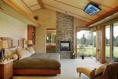 a bedroom with a large bed and fireplace in it