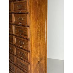 an old wooden filing cabinet with many drawers