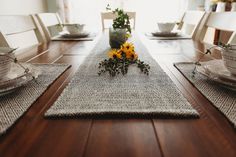 the table is set with sunflowers and placemats for two people to sit at