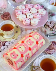 a table topped with lots of desserts and tea