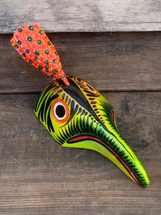 a colorful bird shaped object on top of a wooden table