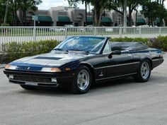 a black sports car parked in a parking lot