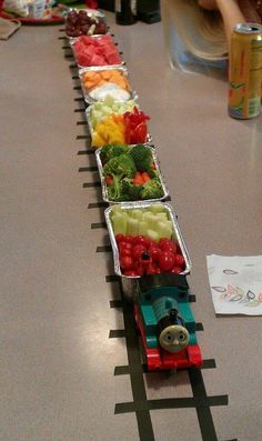 there is a train made out of fruits and vegetables