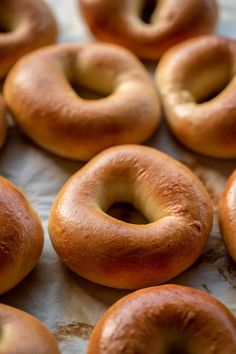 there are many bagels on the table ready to be baked in the oven and eaten