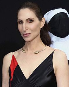 a woman in a black and red dress posing for the camera