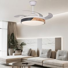 a living room filled with furniture and a ceiling fan