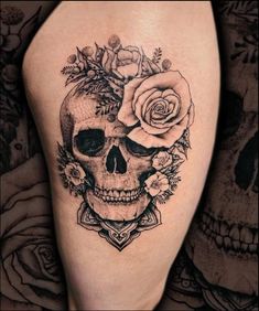 a black and white photo of a skull with flowers on it's head, next to roses