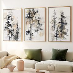 two paintings hang on the wall above a white couch and coffee table in a living room