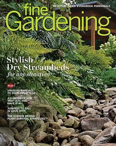 a magazine cover with rocks and plants in the foreground, and a house in the background