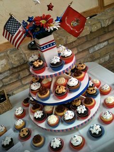 cupcakes are stacked on top of each other in front of an american flag