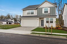 a two story house with grass in the front yard