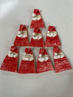 red and white christmas decorations are arranged in the shape of santa claus's hats