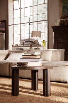 a living room filled with furniture and a large window covered in lots of windows next to a white couch