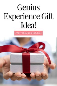 a person holding a present with the words genius experience gift idea