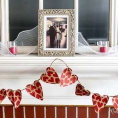 valentine's day mantel decorated with red and white hearts