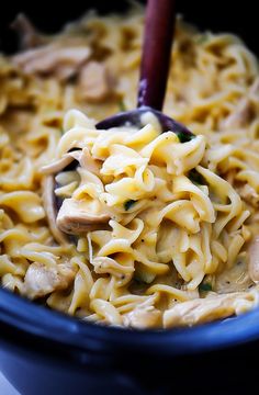 a blue bowl filled with pasta and mushrooms