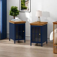 two blue nightstands sitting next to each other on a wooden floor in a room