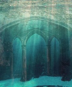 an underwater view of a building in the ocean with sunlight streaming through its windows and water surrounding it