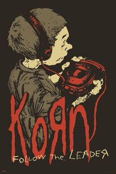 a young boy wearing headphones with the words korn written on it in red