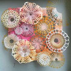 there are many doily pieces on the table with dots and circles all over them