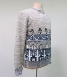 * Mens pullover sweater c 1970s* Heathered beige acrylic yarn* Graphic novelty print design: houses with ship weather vanes on front* Crew neck* Set-in sleeves with folded cuff* Ribbed collar, hem and cuffsLabel: Collageman Excellent conditionBecause it's a knit, there is some flexibility in sizing. Please convo me with any questions.Chest: 44 Shoulders: 19Sleeve: 25 (cuffed)Length: 25Garments are flat-measured. Please compare these measurements to another flat-measured garment that fits you cor Fitted Beige Jacquard Knit Sweater, Beige Knitted Retro Sweater, Retro Beige Knitted Sweater, Retro Beige Knit Sweater, Vintage Cream Knit Sweater, Vintage Cream Sweater With Fair Isle Pattern, Teddy Bear Sweater, Architectural Pattern, Design Houses