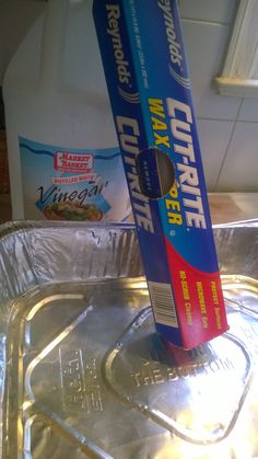 a tube of toothpaste sitting on top of a metal pan