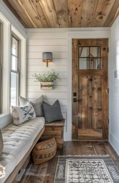 a wooden door sitting inside of a living room next to a white couch and rug