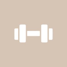 two white dumbbells sitting on top of each other in front of a beige background